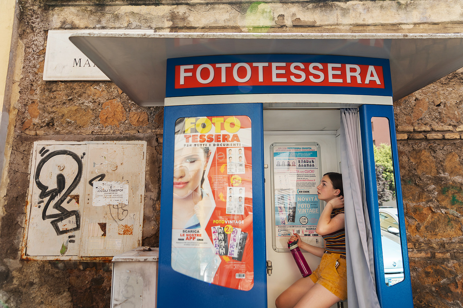 Girl in photo booth in Rome, Italy