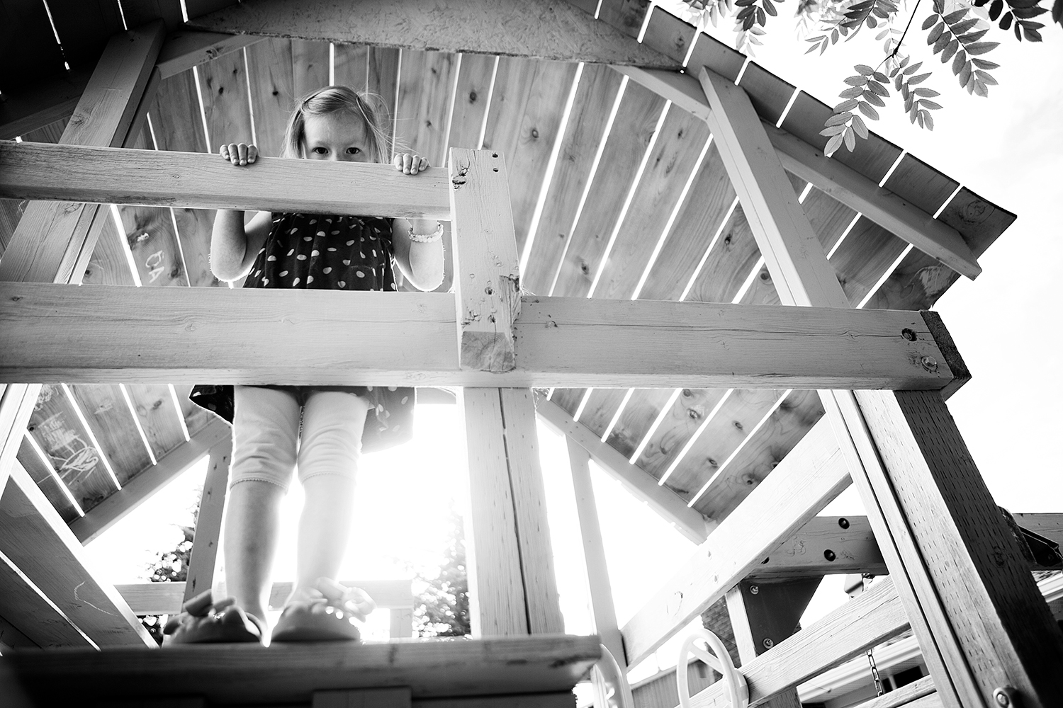 Editorial photograph of a child in a playhouse