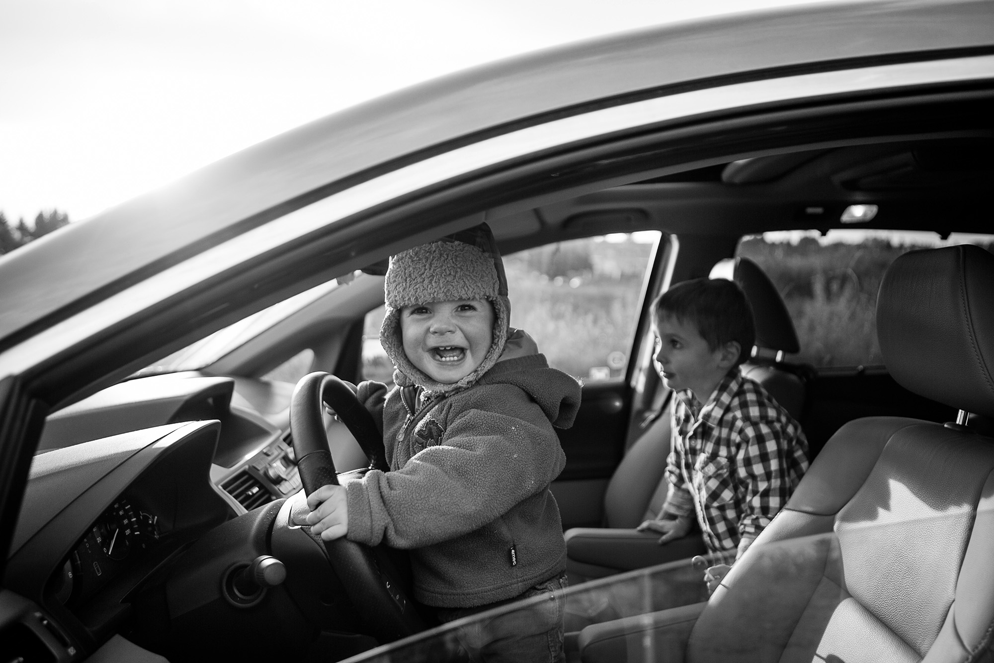 Toddler goofing around in the minivan