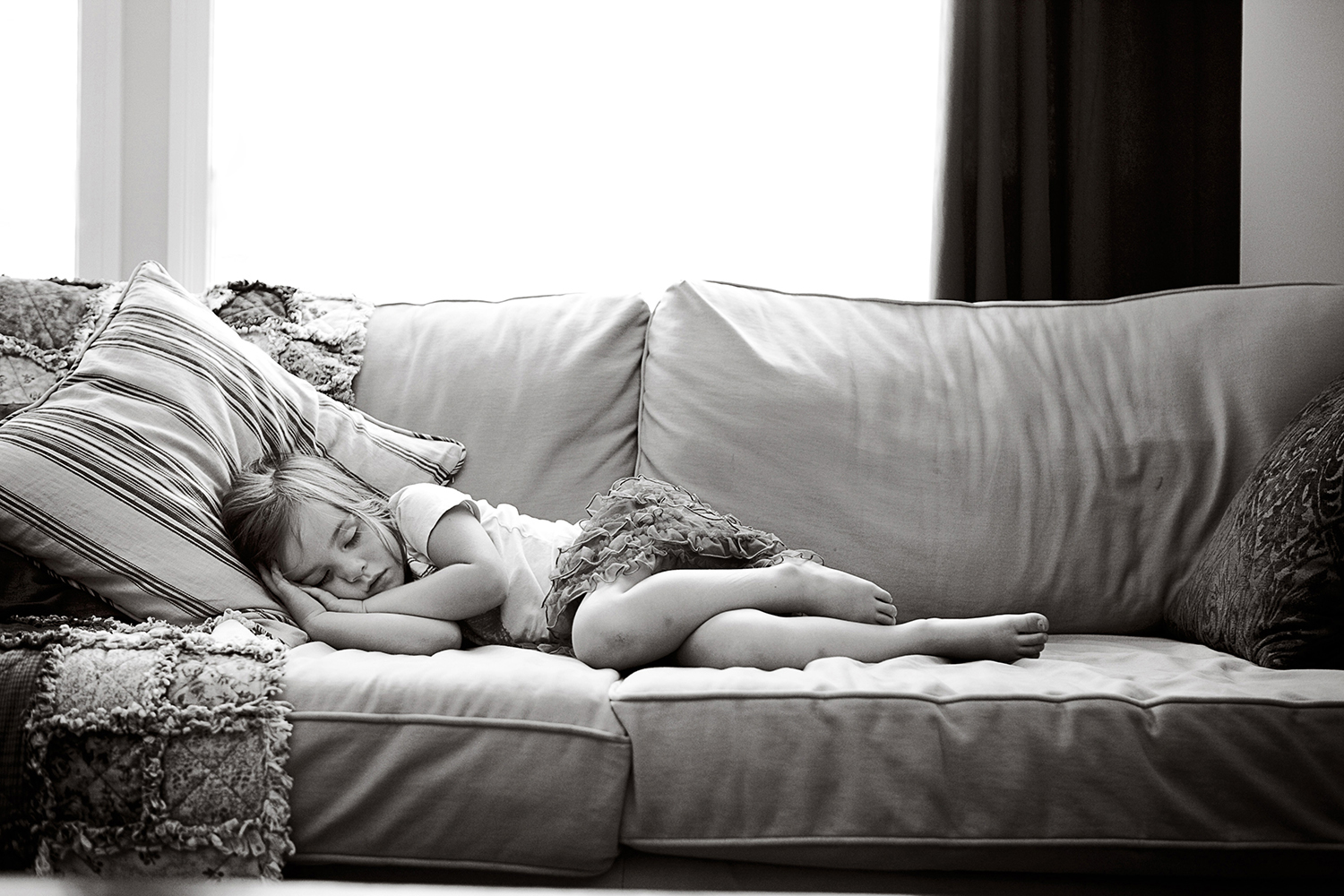Toddler taking a nap in her living room by Dana Pugh