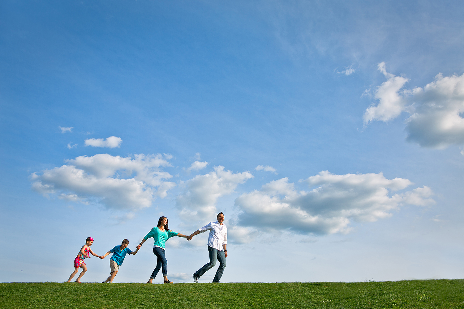 Family walking together under a beautiful blue sky