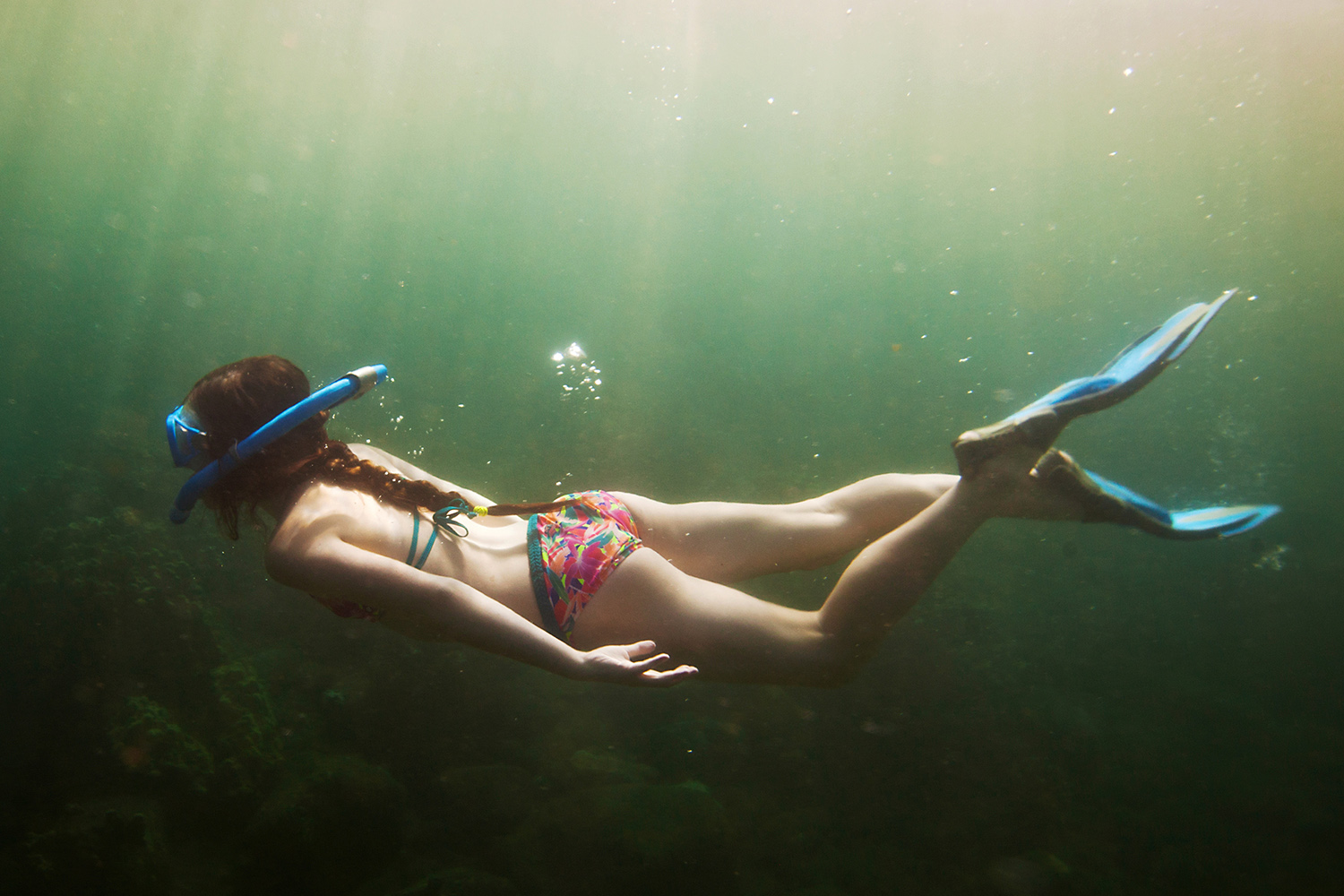 Girl snorkelling underwater in Thailand
