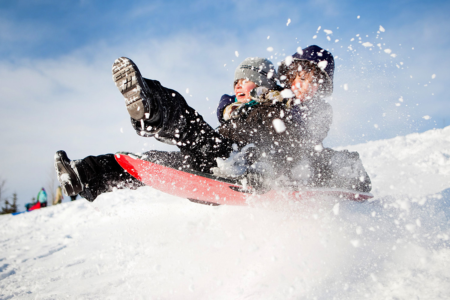 Editorial image of two boys sledding