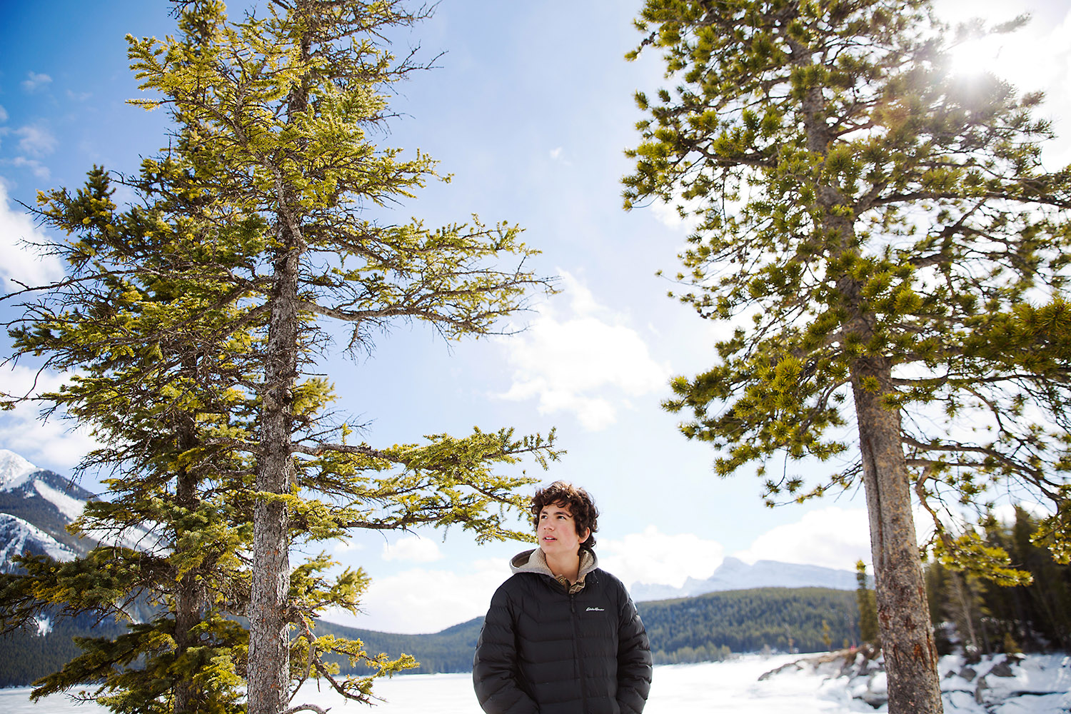 Tenaged boy in the rocky mountains in the winter