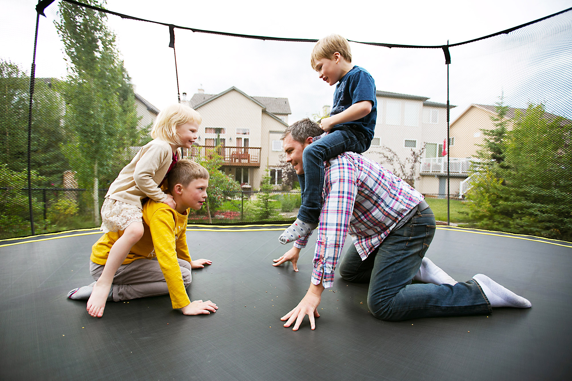 Family playing together on a trampoline