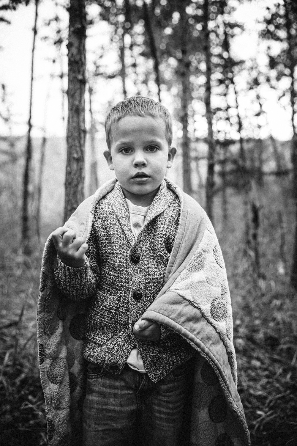 Editorial image of a boy wrapped in his favourite blanket