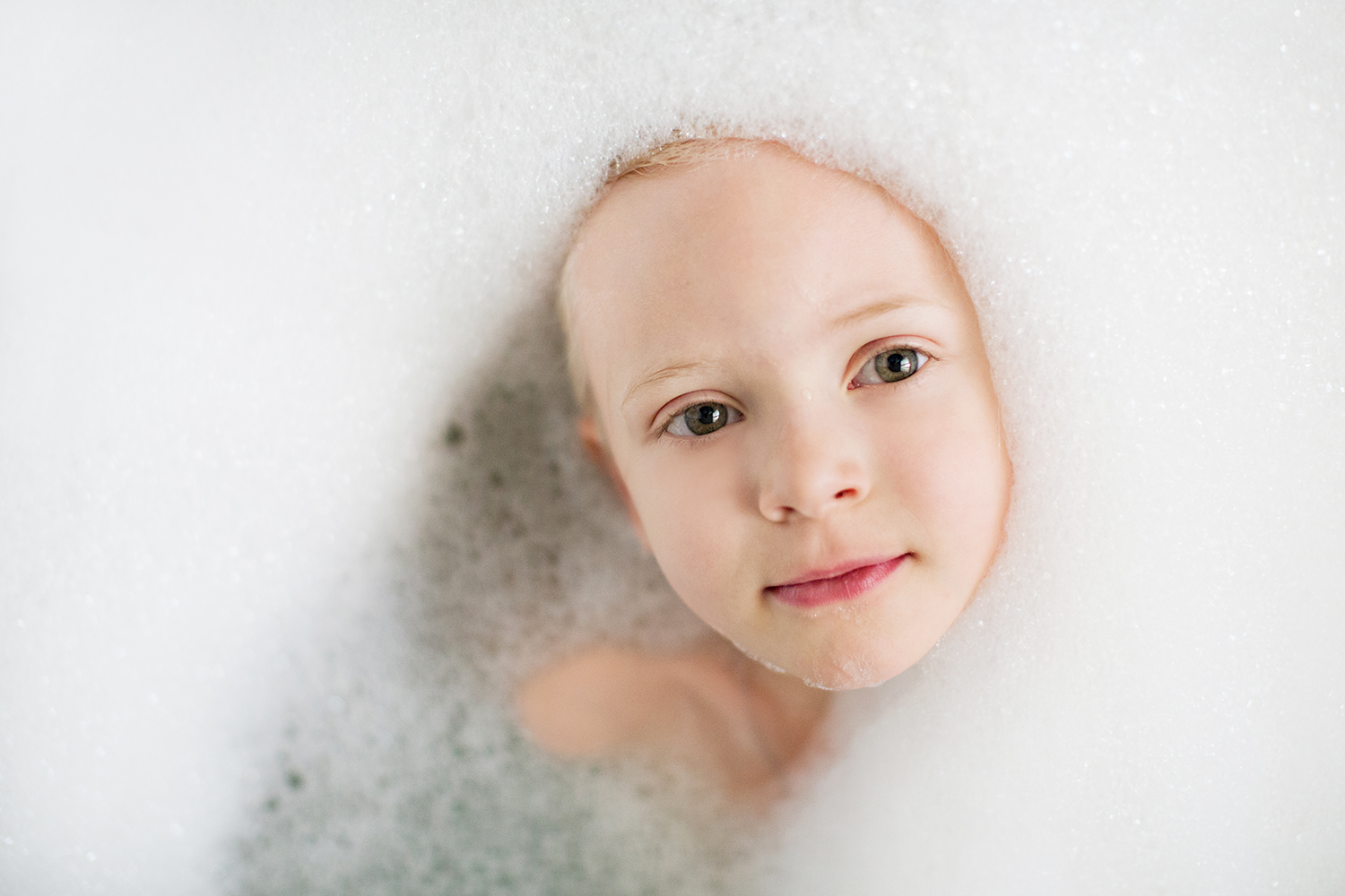 Face of a child amongst the bubbles by Dana Pugh