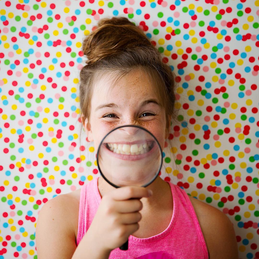 Portrait of a girl with a magnified glass
