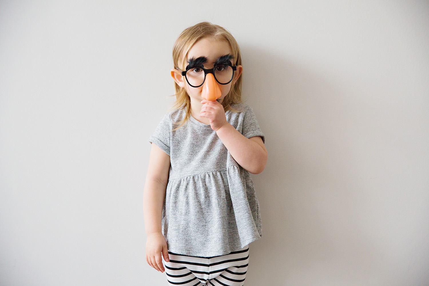 Studio fashion portrait of a child in Groucho Marx Glasses